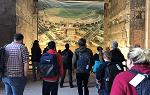 Students looking at a large photo mural of the Templehof airfield